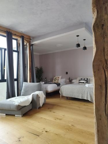 a bedroom with two beds and a large window at Railway by Staynnapartments in Bilbao