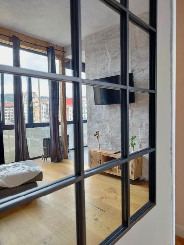a view of a living room through a window at Railway by Staynnapartments in Bilbao