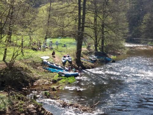 a group of people on a river with boats at Na Statku Babiččino údolí in Česká Skalice