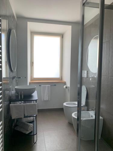 a bathroom with a sink and a tub and a toilet at Palazzo Franceschini in Cascia