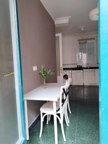 a white table and chairs in a kitchen at Railway by Staynnapartments in Bilbao