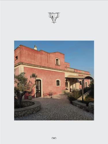 a large red building on a cobblestone street at Villa Pardonise- Puglia-Salento-Casa vacanze in Diso