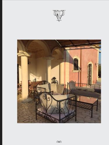 a patio with chairs and a table in a building at Villa Pardonise- Puglia-Salento-Casa vacanze in Diso