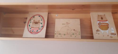 four boxes on a shelf with drawings on them at Комплекс Омайник in Kalofer