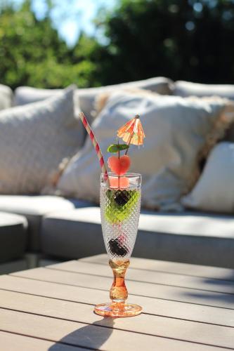 a glass with a drink on a table at Bed & Breakfast Neeltje Soet in Mierlo