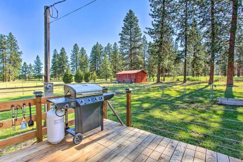 a grill on a wooden deck with a field at Cozy Chiloquin Retreat Less Than 30 Mi to Crater Lake! in Chiloquin