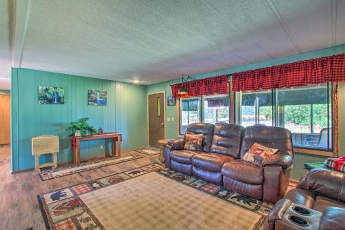 a living room with brown leather furniture and blue walls at Cozy Chiloquin Retreat Less Than 30 Mi to Crater Lake! in Chiloquin
