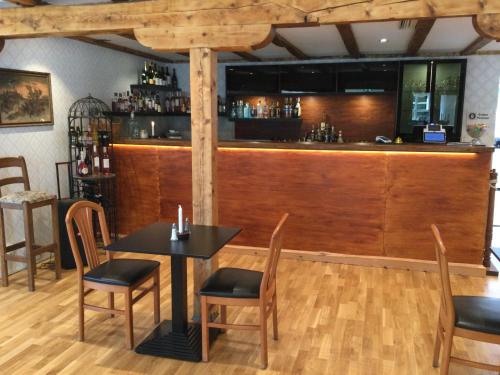 a restaurant with a bar with a table and chairs at Hensbacka Hotell in Munkedal