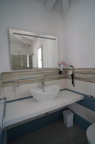 a bathroom with a sink and a mirror at Villa Lentischio in Budoni