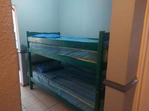 a room with two bunk beds in a room at Pendleberry Holiday Resort - Unit 40 in Bela-Bela