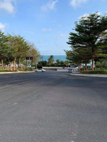 a white car driving down a street with trees at Hotel,Căn Hộ Mũi Né Sea link in Phan Thiet