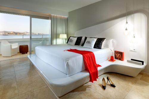 a hotel room with a large bed and a large window at Ushuaia Ibiza Beach Hotel - Adults Only in Playa d'en Bossa