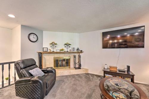 a living room with a chair and a fireplace at Lovely Twin Falls Home with Private Hot Tub! in Twin Falls