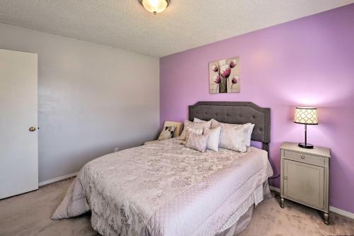 a purple bedroom with a bed and a lamp at Lovely Twin Falls Home with Private Hot Tub! in Twin Falls