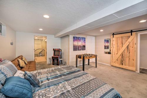 a bedroom with a bed and a sliding barn door at Lovely Twin Falls Home with Private Hot Tub! in Twin Falls