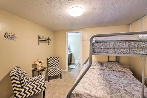 a bedroom with a bunk bed and a chair at Lovely Twin Falls Home with Private Hot Tub! in Twin Falls