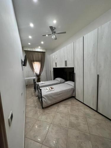 a bedroom with two beds and a ceiling fan at Casa Lucy in Ercolano