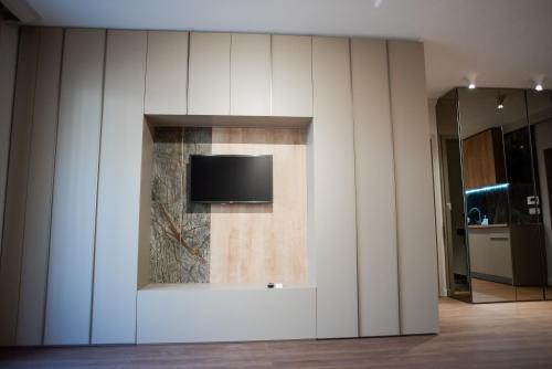 a wall with a tv on it in a room at Opera Apartments in Cluj-Napoca