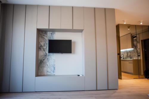 a tv on a wall in a room at Opera Apartments in Cluj-Napoca