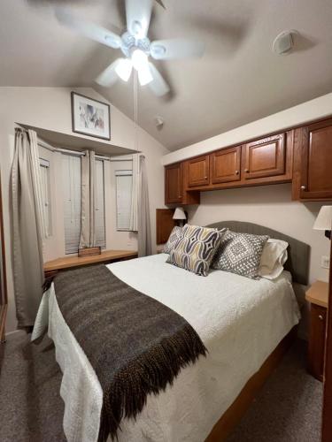 1 dormitorio con 1 cama y ventilador de techo en Berry Patch Cottage en Longview
