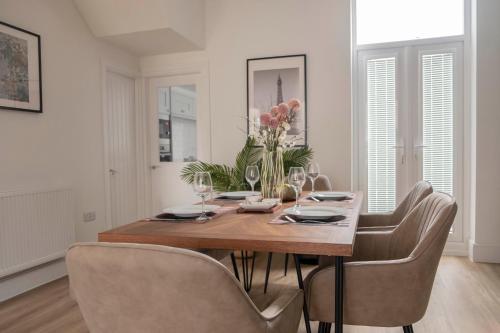 a dining room with a wooden table and chairs at The Callie by Sasco Apartments in Blackpool