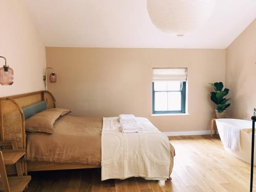 a bedroom with a bed and a window at Luxury bolthole in central St.Agnes with parking. in St. Agnes