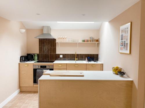 a kitchen with a stove and a counter top at Luxury bolthole in central St.Agnes with parking. in St. Agnes