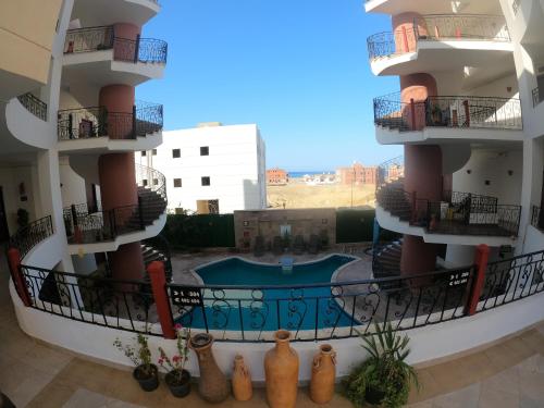 an apartment building with a pool in the middle at Oasis marsa alam in Marsa Alam City