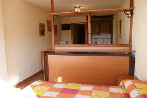 a bedroom with a bed and a dresser with a mirror at Estudio con vistas Edificio Bulgaria in Sierra Nevada