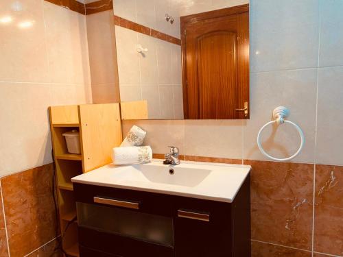 a bathroom with a sink and a mirror at Holiday for you Callao in Callao Salvaje
