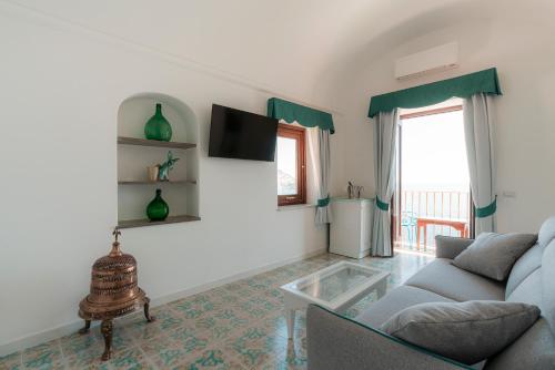 a living room with a couch and a table at Villa Nettuno in Positano