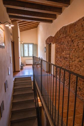 a staircase in a building with a stone wall at Agriturismo Cascina Pezzolo in Lodi