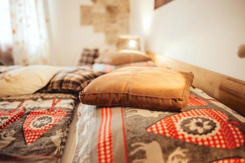 a bed with two pillows on top of it at Das Hotel Stern, B&B KG - digital & contactless check-in in Sankt Gilgen