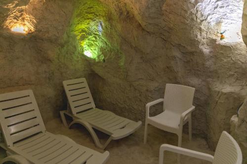 a group of chairs sitting in a cave at Стаи за гост Хит Хаус и СПА in Bratsigovo