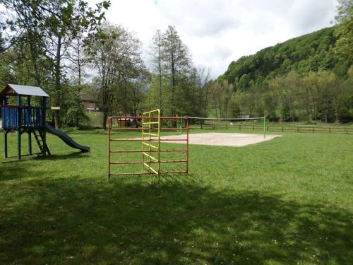 a park with a playground with a slide at Green Valley Park in Stárkov