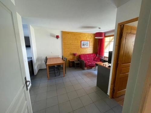 a kitchen and a living room with a table at Appartement Les Chalets de Belledonne in Saint-Colomban-des-Villards