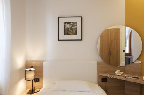 Postel nebo postele na pokoji v ubytování Hotel Ristorante Alla Vittoria