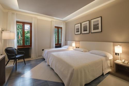 Postel nebo postele na pokoji v ubytování Hotel Ristorante Alla Vittoria