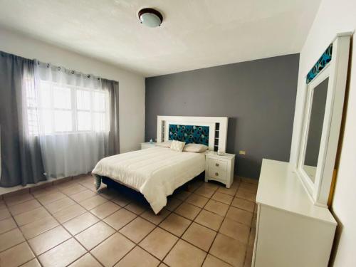 a bedroom with a white bed and a window at Casa Ragma in Parras de la Fuente
