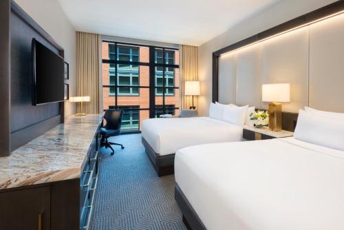 a hotel room with two beds and a desk at InterContinental - Washington D.C. - The Wharf by IHG in Washington
