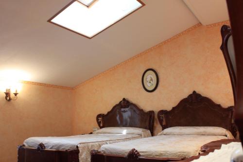 a bedroom with two beds and a skylight at AZTIETA CASA RURAL in Leitza