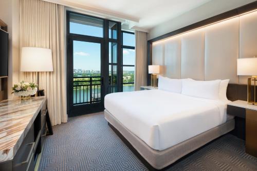 a hotel room with a bed and a large window at InterContinental - Washington D.C. - The Wharf by IHG in Washington