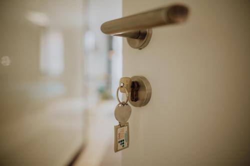 a key hanging from a door with a door knob at Das Hotel Stern, B&B KG - digital & contactless check-in in Sankt Gilgen