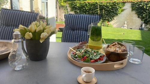 a table with a tray of food and a bottle of wine at MonPe apartmánik s atmosférou in Komárno