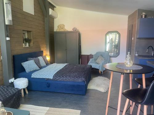 a bedroom with a bed and a table and chairs at MonPe apartmánik s atmosférou in Komárno