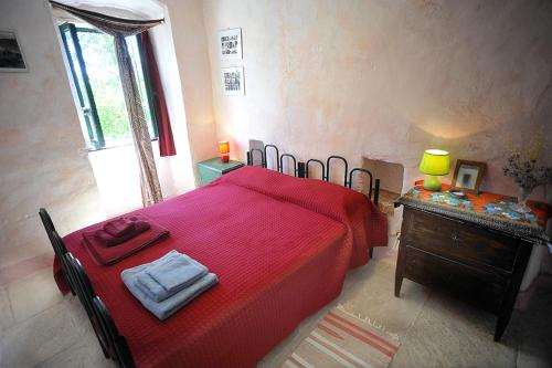a bedroom with a large red bed and a dresser at chevalier claudio in Agnone