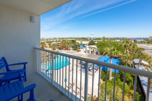 a balcony with a view of the pool and the ocean at The Island Resort at Fort Walton Beach in Fort Walton Beach