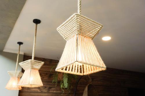 two lights are hanging from a ceiling at Chairu Eco Hotel in Santa Cruz de la Sierra