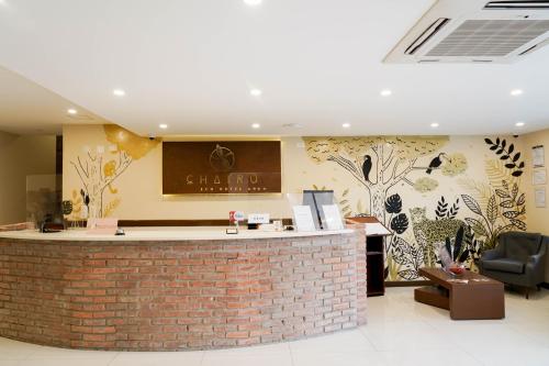 a bar in a lobby with a brick wall at Chairu Eco Hotel in Santa Cruz de la Sierra