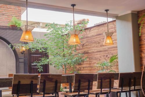 a group of lights hanging over a table with chairs at Chairu Eco Hotel in Santa Cruz de la Sierra